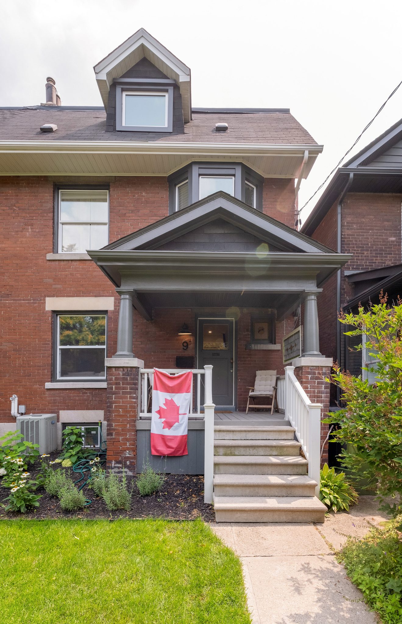 Renovated century semi exterior with rebuilt front porch, High Park, Toronto
